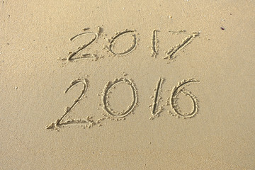 2016 2017 inscription written in the beach sand. Concept of cele