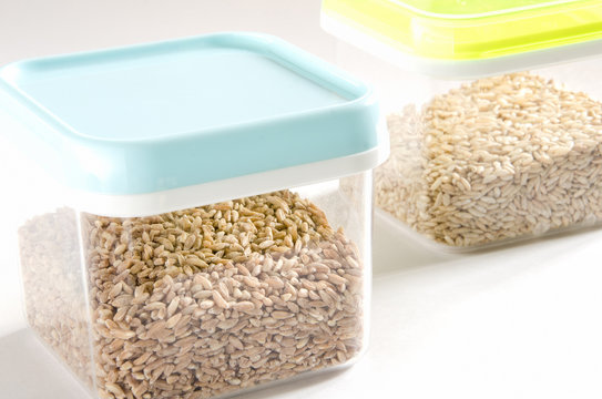Food storage. Food ingredients (spelt wheat and wild rice) in plastic containers. Selective focus.