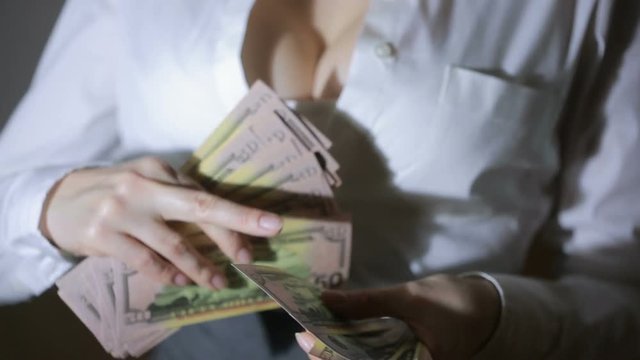 Beautiful young slim girl considers money
