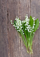 lilies of the valley on the wooden surface