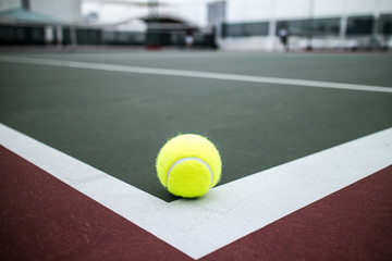 Tennis ball on hard court