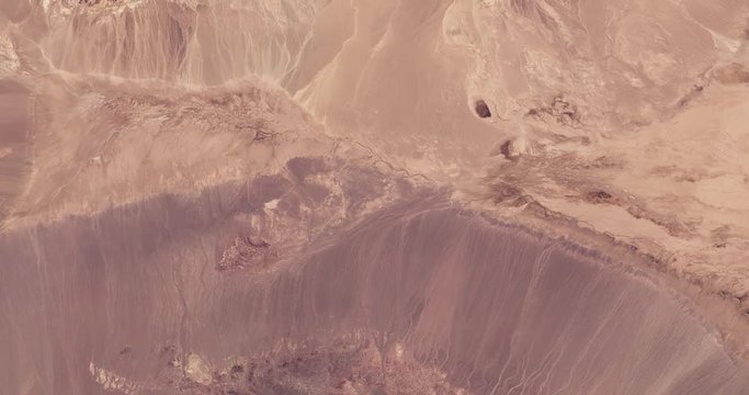 High-altitude overflight aerial of Iran's Dasht-e Kavir (Great Salt Desert). Clip loops and is reversible. Elements of this image furnished by USGS/NASA Landsat 