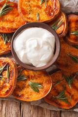Grilled sweet potatoes with sour cream closeup. vertical top view