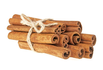 Cinnamon sticks tied with a natural rope, isolated on white back