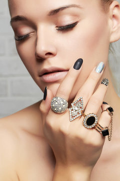 beauty face.woman's hands with jewelry rings.beautiful girl with make-up and manicure