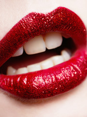 Obraz premium beautiful red lips with glitter.event make-up.part of woman face