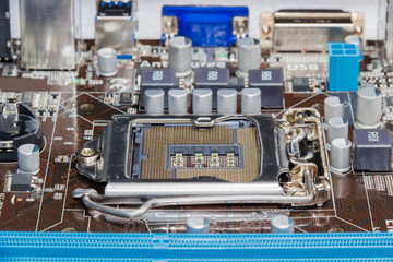 Fragment of motherboard of a desktop with CPU socket closeup
