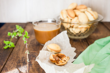 nuts cake with condensed milk and coffee on the table, selective focus
