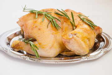 the baked carcass of chicken in a dish on a table, selective focus