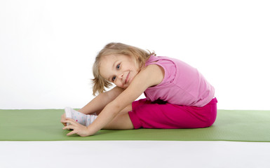 child doing gymnastics on a mat