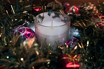 Burning candle and Christmas decoration, elegant low-key with festive mood