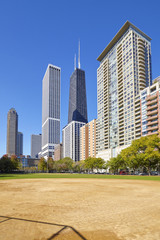 Fototapeta na wymiar Chicago city downtown buildings seen from a playing field on a sunny day, USA.