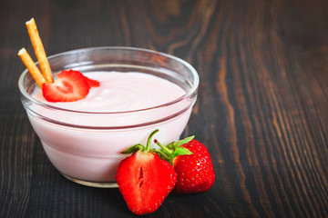 Healthy and tasty dessert of strawberries with yogurt for breakfast.