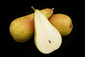Pears of yellow color on a black background (closeup)