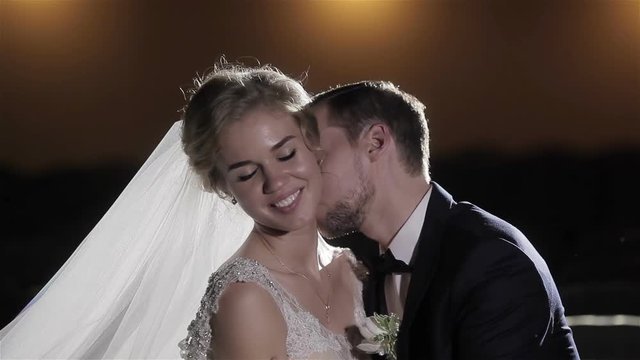 Man seduce woman kissing her neck gallantly close up slow motion. Couple lovers flirt in tempting love and sensuality. Charming bride smiling happy while groom tenderly making attempt to allure