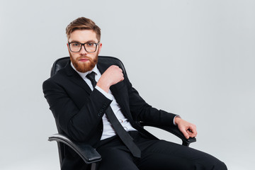Business man in glasses on armchair