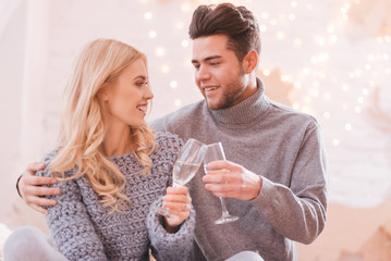 Happy pleasant couple drinking champagne