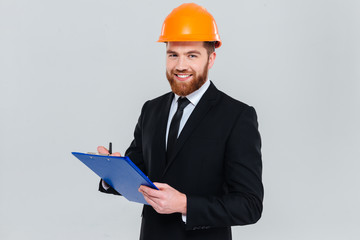 Smiling engineer with clipboard