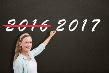 Composite image of smiling teacher writing over white background