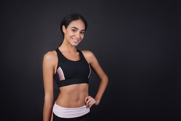 Smiling attractive sportswoman looking at camera