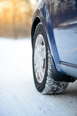 Close-up Image of Winter Car Tire on the Snowy Road. Drive Safe.