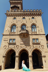 Newlyweds kiss in the arch of old Italian house