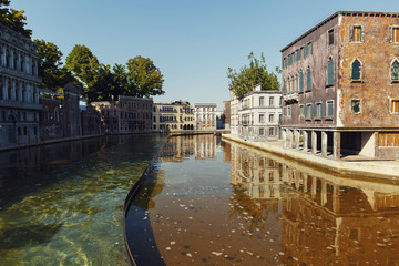 Obraz premium Canal lies among old stone buildings in Italian city