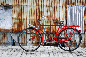 Retro vintage red bike on  street in the old town. Color in blac