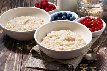 homemade oatmeal and berries on wooden table