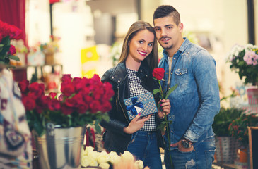 Relations, love, romance concept -  happy young couple with flowers