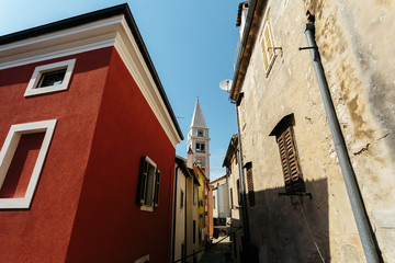 Fototapeta na wymiar Church of Saint Anthony rises between houses European city Vrsar, Croatia.