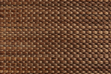 Bamboo woven brown mat handmade background. Wicker wood texture. Horisontal strips.