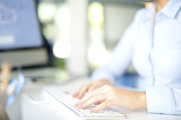 Close-up shot of woman hands while typing on keyboard