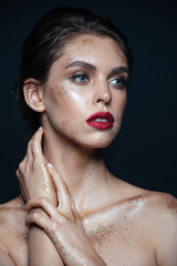 Beauty portrait of pretty young woman with shimmering makeup