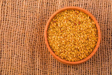 light flax seeds in a wooden bowl