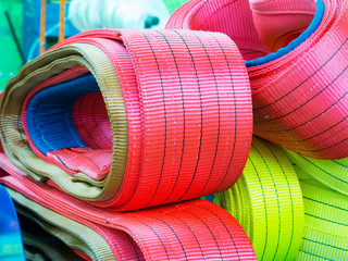 Colorful nylon soft lifting slings stacked in piles
