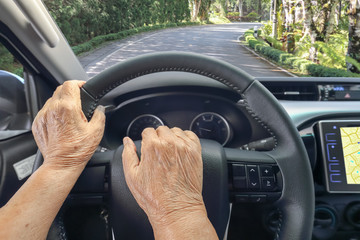 Senior woman driving a car with gps map