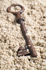 Key lost in sand.