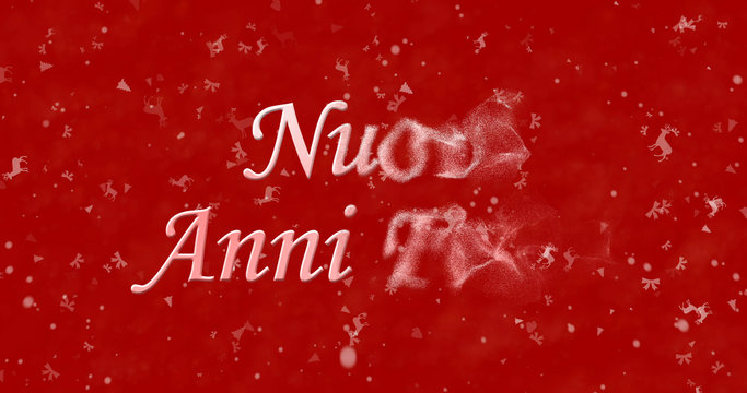 Happy New Year text in Italian "Nuovi anni felici" turns to dust from bottom on red background