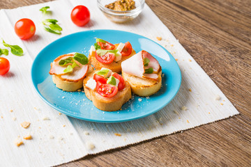 Bruschetta with tomato, cheese and bacon