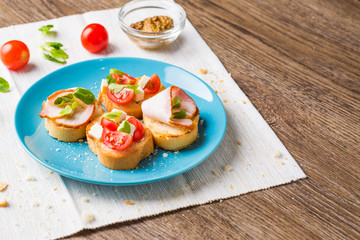 Bruschetta with tomato, cheese and bacon