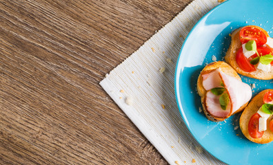 Bruschetta with tomato, cheese and bacon