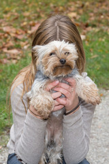 young blond girl behind the little dog