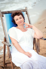 Beautiful adult woman relaxing on beach