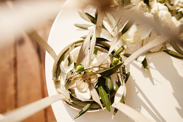 wedding rings in olive leaves macro - Powered by Adobe