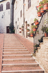  Staircase street of the old town of Assisi with ancient stone h