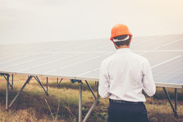 engineer working on checking and maintenance equipment at green energy solar power plant: