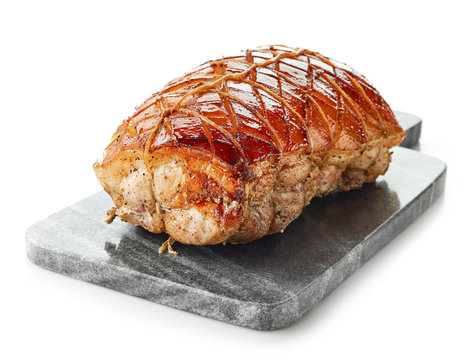 roasted pork on gray cutting board