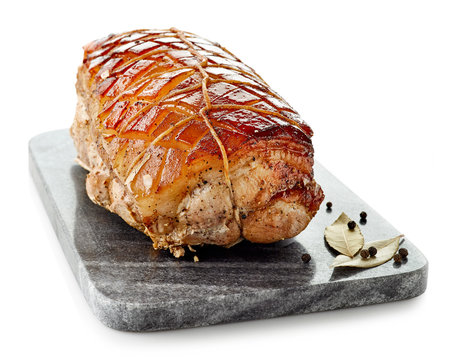 roasted pork on gray cutting board