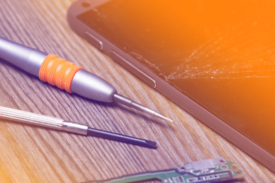 screwdriver and dismantle the phone